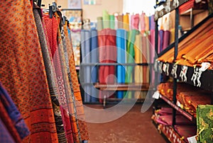 Colorful printed textiles on display in a fabric store