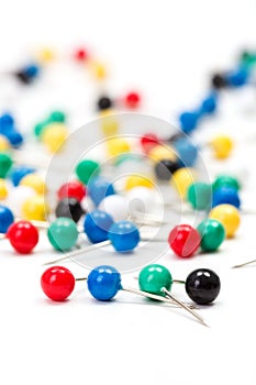Colorful push pins on white