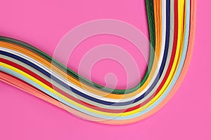 Colorful quilling, twisting paper, abstract rainbow on pink background