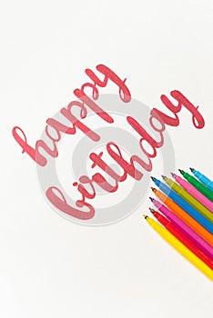 Colorful quote `Happy birthday` handdrawing with red marker on white paper