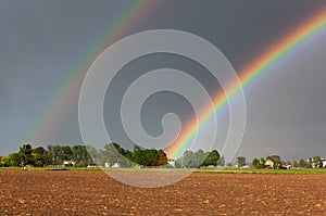 Colorful rainbow against the background of a dangerous, stormy sky