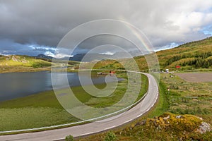 Colorful Rainbow over the road to Unstad in Lofoten islands, Norway