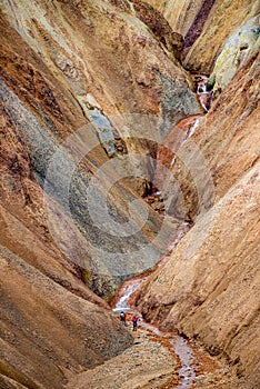 Colorful rainbow rhyolite volcanic mountains Landmannalaugar as pure wilderness in Iceland and hikers, summer time