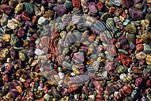 Colorful Rainbow Rocks in a Glacier Lake