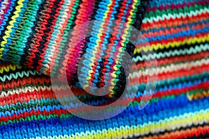 Colorful rainbow striped wool textile close up with folds