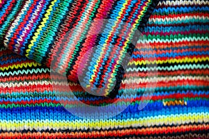 Colorful rainbow striped wool textile close up with folds