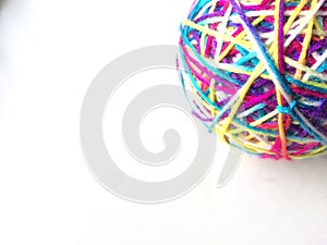 Colorful rainbow yarn ball cat toy white background pink yarn bright