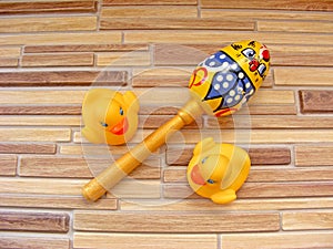 Colorful rattle baby toy isolated on bamboo background