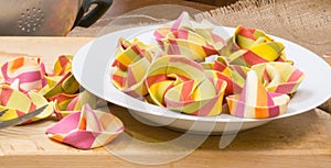 Colorful ravioli pasta with a white plate, canvas and wooden board