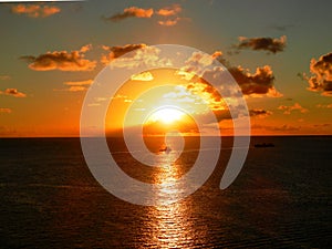 Colorful reach sunset with clouds sea and a ship