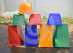 Colorful recycle bins to dry outside.
