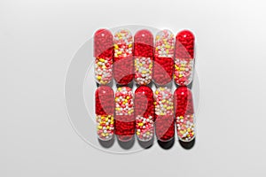Colorful red capsule pills on isolated white background with copy space. Antibiotic drug resistance. Pharmaceutical
