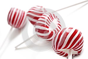 Colorful red lollipops on white background
