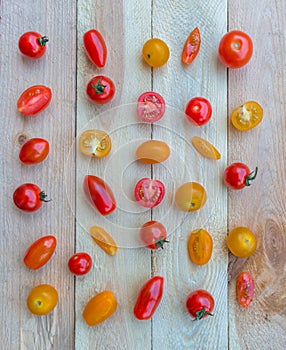 Colorful red, orange and yellow cherry tomatoes on wooden background