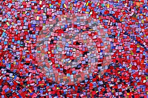 Colorful red, pink, yellow, and purple stone mosaic tiles on the wall