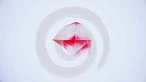 Colorful red shiny polyhedron crystal randomly transforming on white glamour background. Quality motion dynamic animated