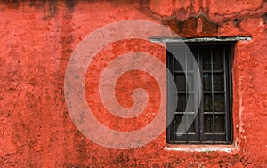 Colorful red vintage retro window and wall of an old house building.