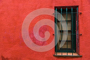 Colorful red vintage retro window and wall of an old house building.