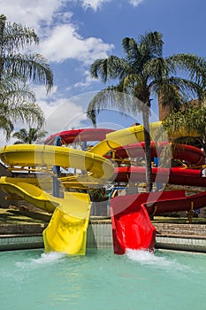 Colorful red and yellow water slide in aqua park.