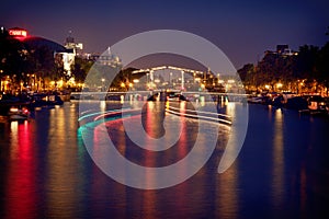 Colorful Reflection of Magere Brug Bridge in Amsterdam at Night