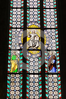 Colorful religious stained glass window in St. Vitus Cathedral i