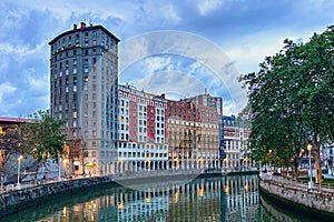 Colorful residential and apartment buildings and restaurants along the Nervion River photo