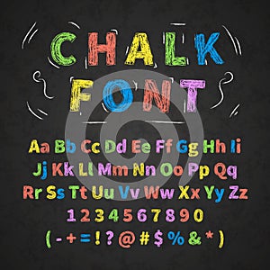 Colorful retro hand drawn alphabet letters drawing with chalk on black chalkboard