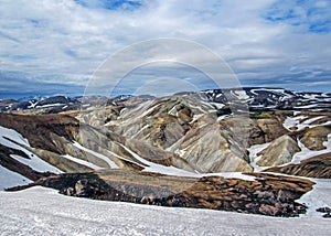 Colorful rhyolite mountains covered with snow in Jokultungur geothermal area, Laugavegur, Fjallabak Nature Reserve, central