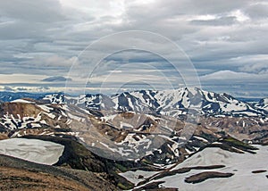 Colorful rhyolite mountains covered with snow in Jokultungur geothermal area, Laugavegur, Fjallabak Nature Reserve, Highlands of