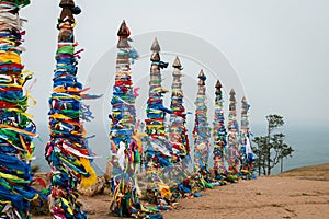 Colorful ribbons on wooden poles at Lake Baikal in Siberia