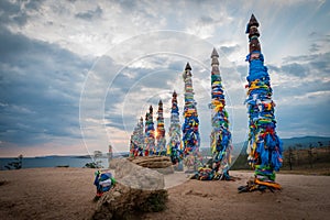 Colorful ribbons on wooden poles at Lake Baikal in Siberia