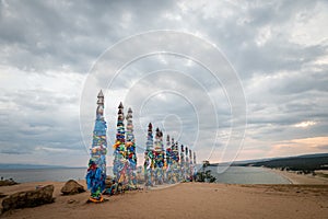 Colorful ribbons on wooden poles at Lake Baikal in Siberia