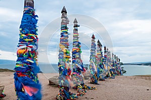 Colorful ribbons on wooden poles at Lake Baikal in Siberia