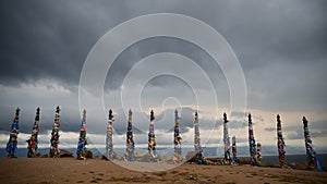 Colorful ribbons on wooden poles at Lake Baikal in Siberia