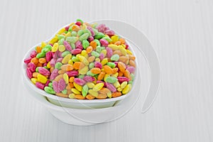 Colorful Rice Cereal on the pink dishcloth with glass of water a