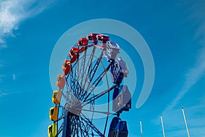 Colorful ride in motion in amusement park on sky background