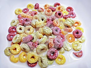 Colorful Ring-Shape Fruity Cereal with Milk in White Bowl