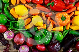 Red, green, yellow peppers, onion, eggplant on table