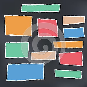 Colorful ripped striped note, copybook, notebook paper stuck on black background.