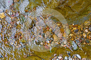 Colorful river pebbles under the water. Rocks in the stream