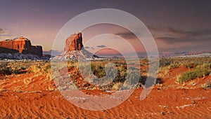 Colorful rock formation at dusk with a dusting of snow in Monument Valley