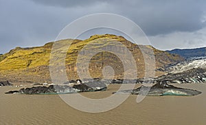 Colorful Rocks and Ice by a Glacial Lagoon