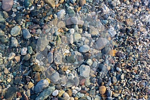 Colorful rocks and pebbles under the clear water