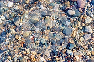 Colorful rocks and pebbles under the clear water