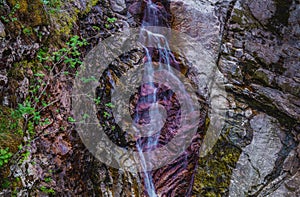 Colorful rocks, water erosion, a small waterfall