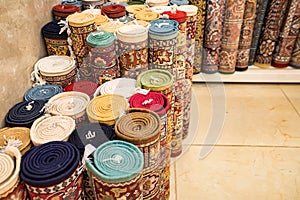 Colorful rolled carpets in oriental marketplace