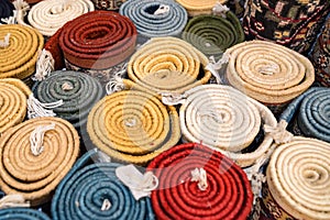 Colorful rolled carpets in oriental marketplace