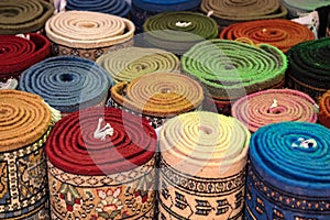 Colorful rolled carpets in oriental marketplace