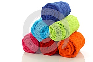 Colorful rolled up and stacked bathroom towels