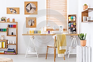 Colorful room interior with a desk, sewing machine and threads